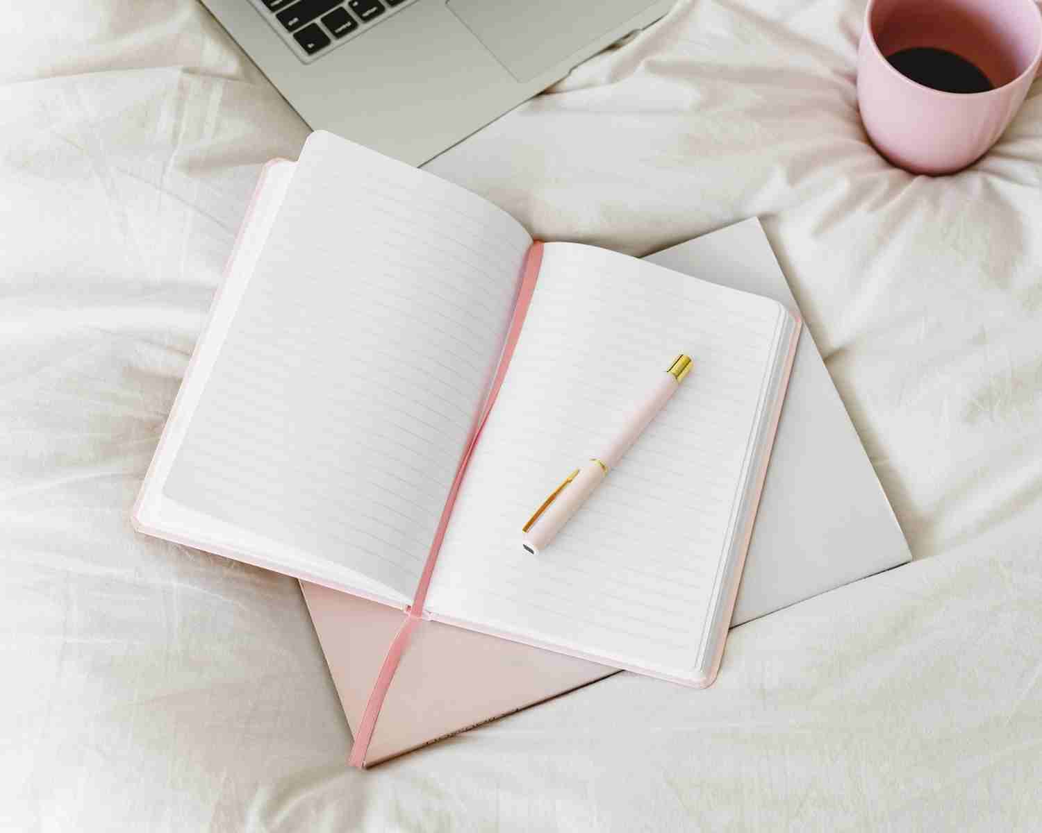 Getting Started with Tiny Writing - notebooks, Pen, and laptop on bed