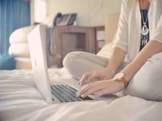 Women sitting on bed with laptop