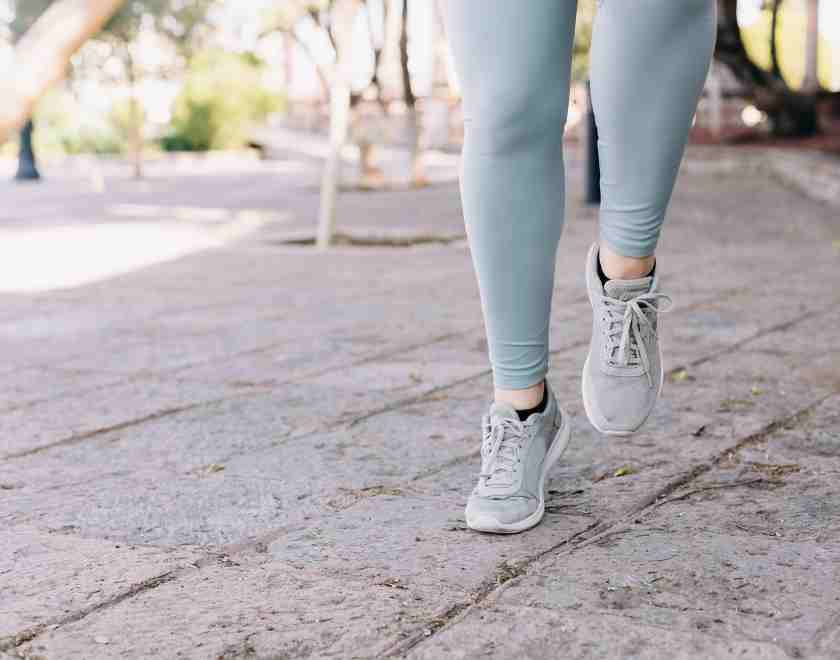 Woman running in gray leggings and sneakers