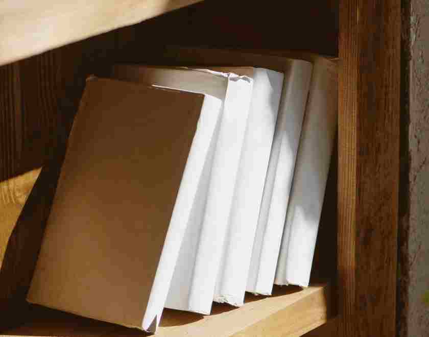 white covered books onbookshelf to symbolize efforts to ban books