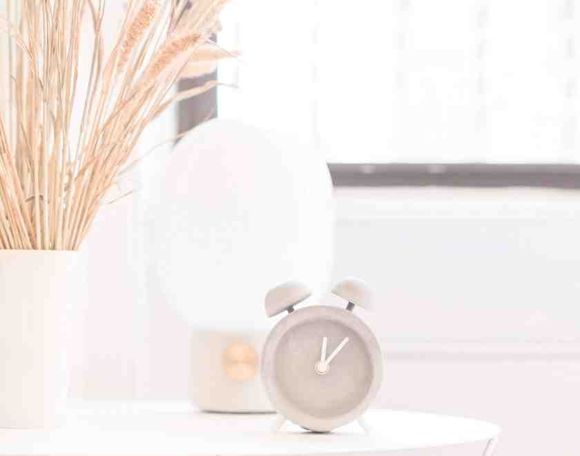 Cover image for plan ahead post with clock ont able and vase of grasses